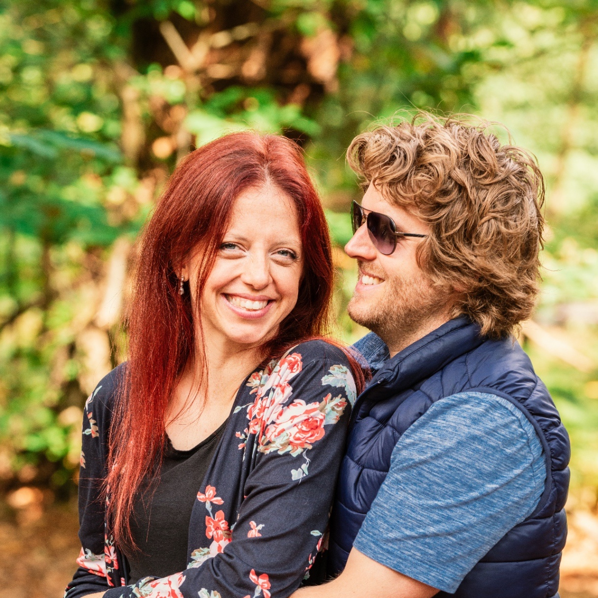 Founder with her partner smiling in a forest